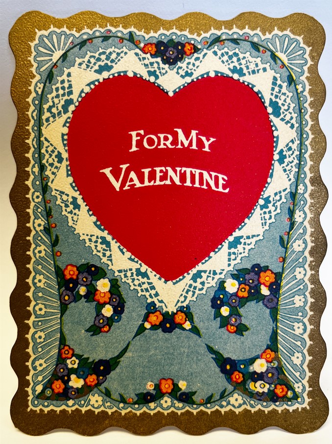 Card reading "For My Valentine" on a red heart with a lace decorative border.
