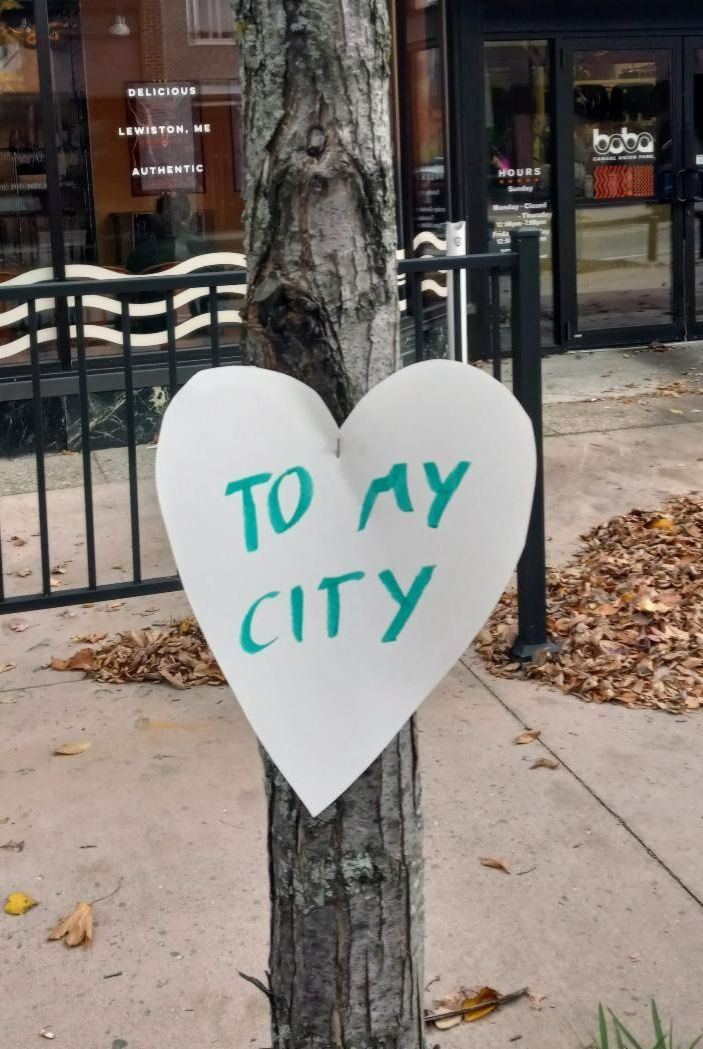 A paper heart reading "to my city" attached to a tree on Lisbon Street in Lewiston, Maine.