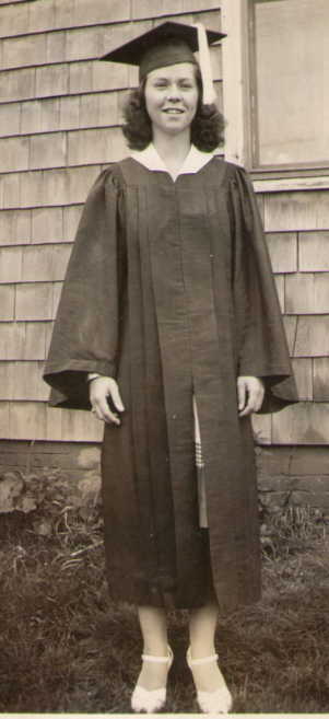 Young woman posed in a graduation cap and gown. 