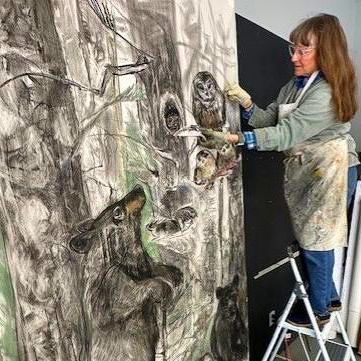 Rebekah Raye painting in her studio.