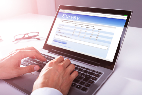 Close-up Of A Businessman s Hand Filling Online Survey Form On Laptop