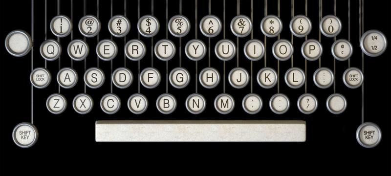 An extreme close up of the keys of a vintage typwriter on a dark background