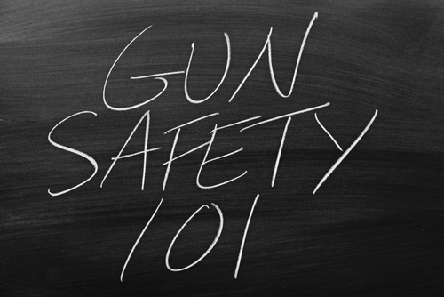 The words  Gun Safety 101  on a blackboard in chalk