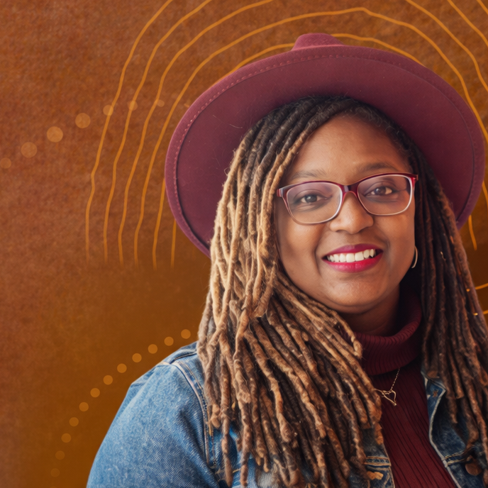 Photo of Amittia Parker, PhD, LMSW, MPA, from Georgetown University, smiling and wearing glasses and a purple hat