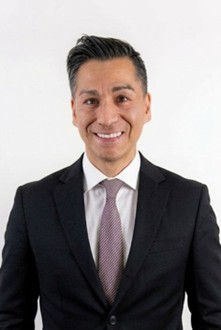 Man smiling wearing black suit