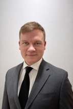 Man wearing charcoal gray suit
