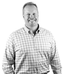 Man smiling wearing checkered shirt