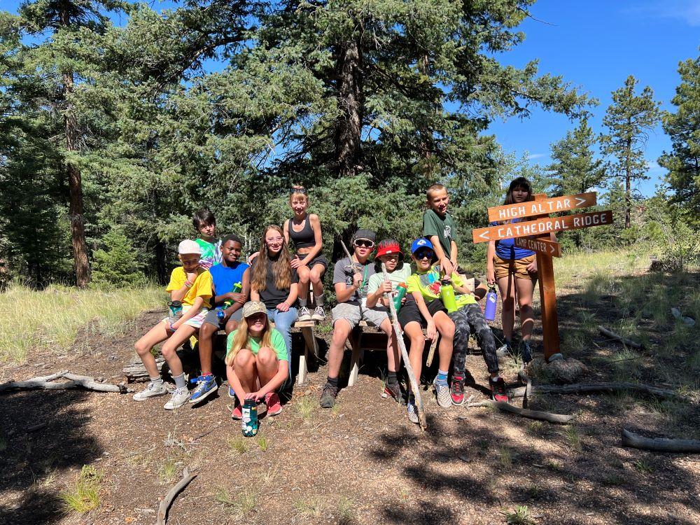 A group of campers posing at a fork in the trail at Cathedral Ridge.