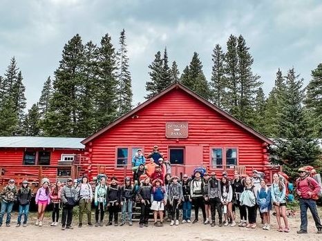 Duncan Park's red main building with a crew of campers out front