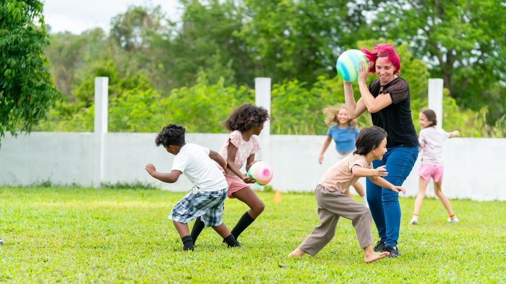 Summer camp teen with students