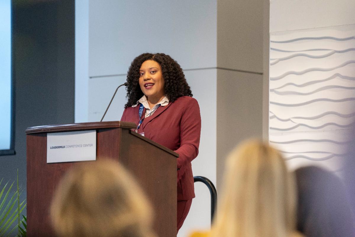Avivah McPherson a black woman and a keynote speaker at podium