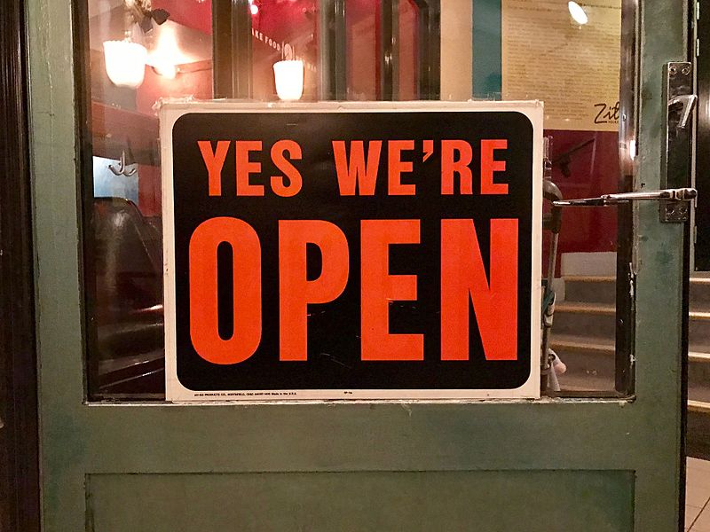 Yes We_re Open sign on a door