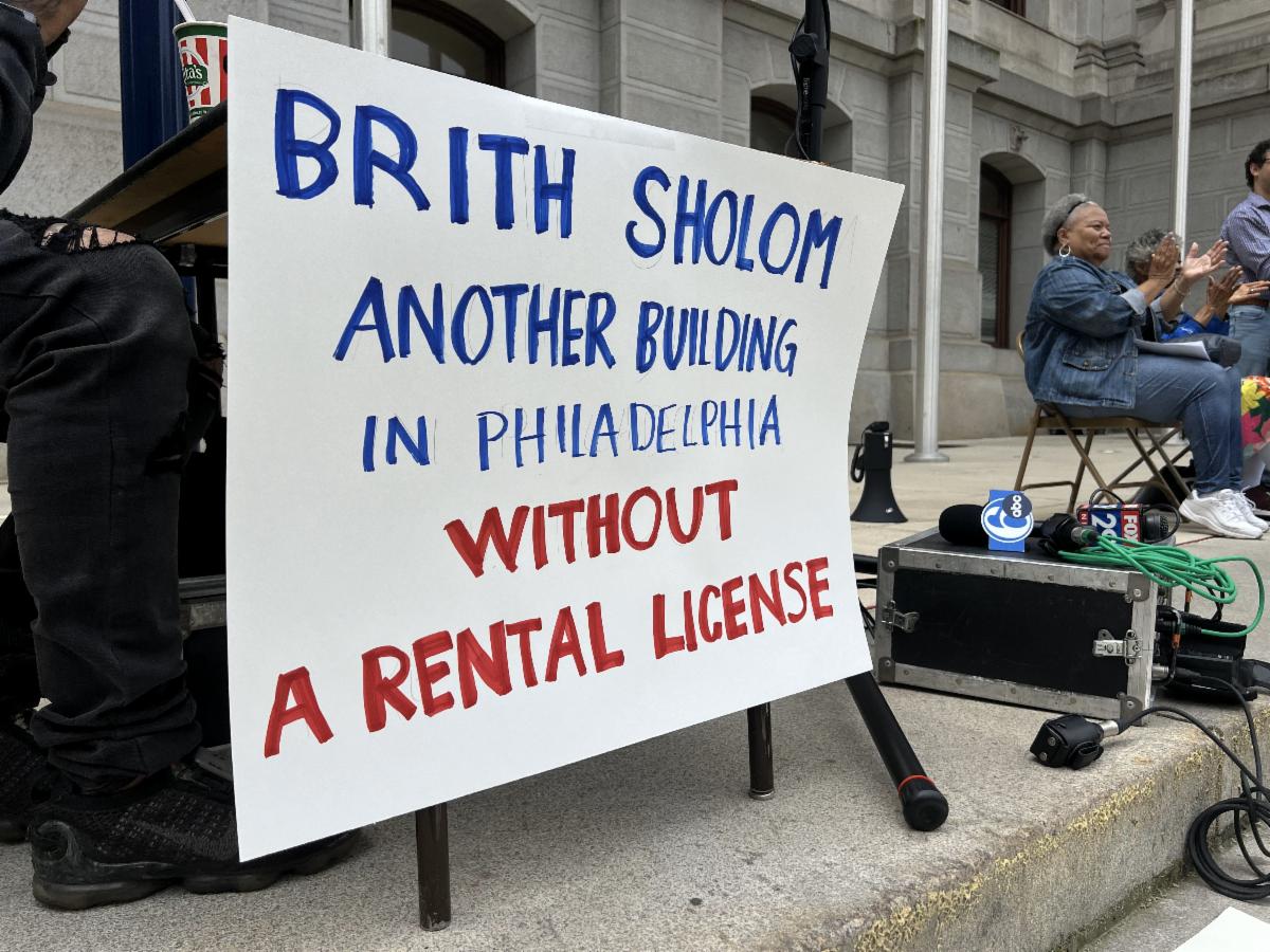 A sign from the rally in front of city hall, reading "Brith Sholom another building in Philadelphia without a rental license."