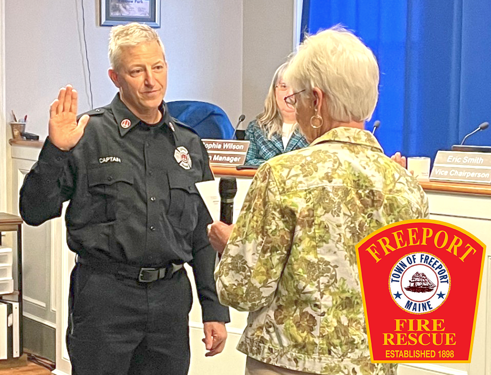 man in firefighter uniform with raised hand responding to woman reading swearing in protocol