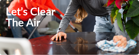 let's clear the air banner showing a person bent over a table cleaning away dush with a cloth