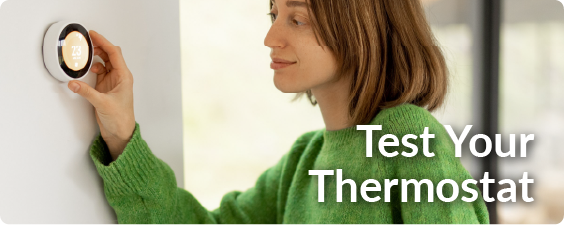 a woman testing her thermostat