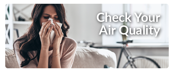 a woman sneezing into a tissue with the words Check Your Air Quality on the right side