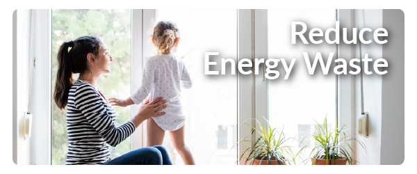 a woman in a striped shirt holding up a toddler with the words Reduce Energy Waste superimposed on it