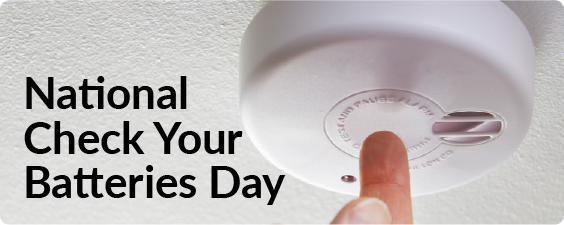 banner for national check your batteries day showing a finger test the button on a smoke detector 