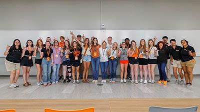 A group of students pose in front of a whiteboard.