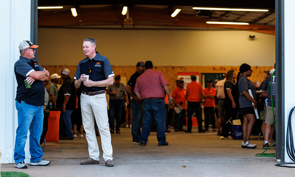 Wade Thomason and Jayson Lusk stand off to the left with participants behind during the Turf and Landscape Field Day.