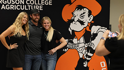 Ferguson students pose in front of a Ferguson College of Agriculture display.