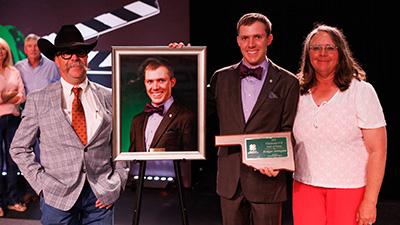 Bridger Arrington and his parents with his Oklahoma 4-H Hall of Fame award.