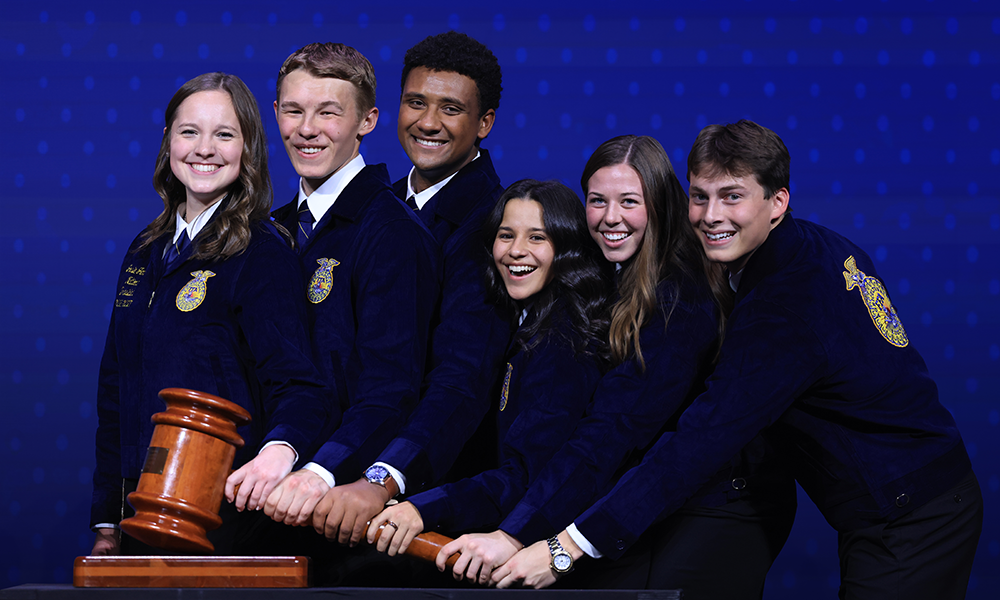 The newly elected National FFA Officer team holds the gavel on stage at National FFA Convention.