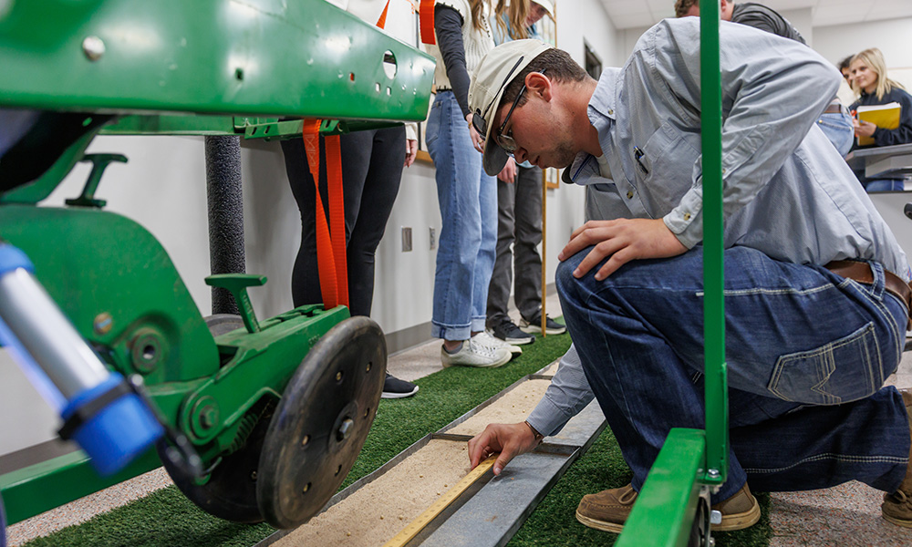 Students working with plant and soil science equipment.