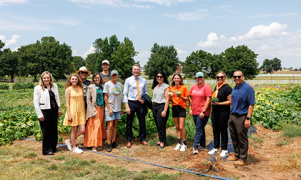 Secretary Blayne Arthur with guests at the OSU Student Farm.