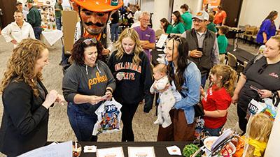 People gather for an Extension open house with Pistol Pete.