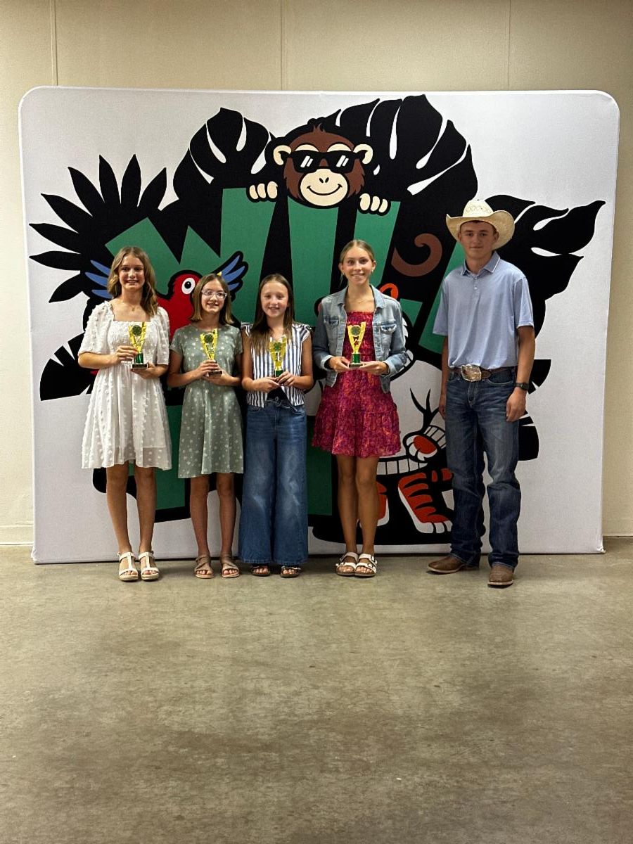 Farm Bureau Award recipients pose with their trophies and the award presenter during the Blaine County 4-H Achievement Banquet.