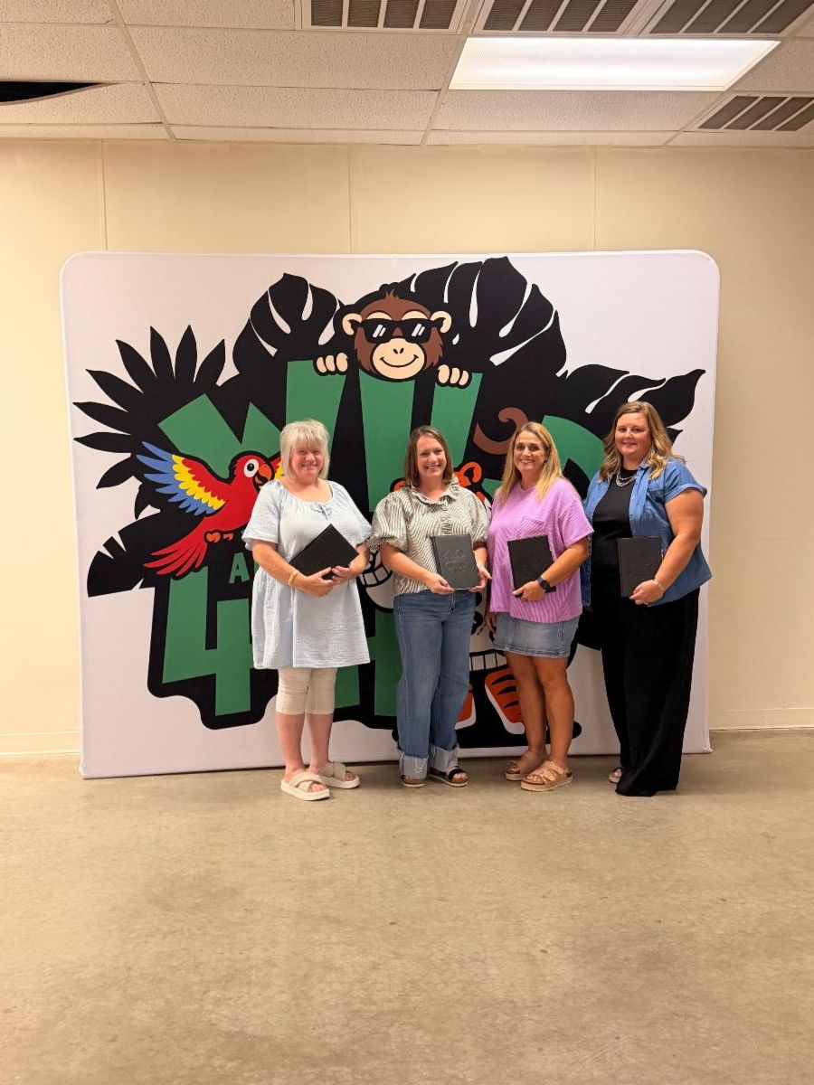 4-H club leaders from the Okeene and Watonga 4-H Clubs pose with recognition folders during the Blaine County 4-H Achievement Banquet.