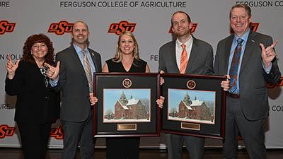 Two Early Career Achievement Award recipients pose with their awards and three Ferguson College of Agriculture faculty. 