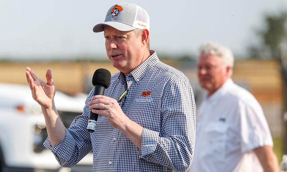Dr. Lusk speaks into a microphone at the Lahoma Field Day.