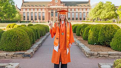 Jacie Wolfinger wears the orange gown.
