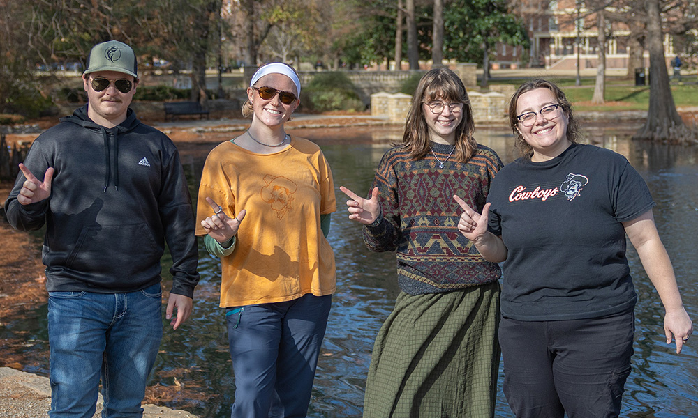 Caleb Rigdon, Liz Knam, Annabelle Pearce, and graduate student Grace Shea gather at Theta Pond.