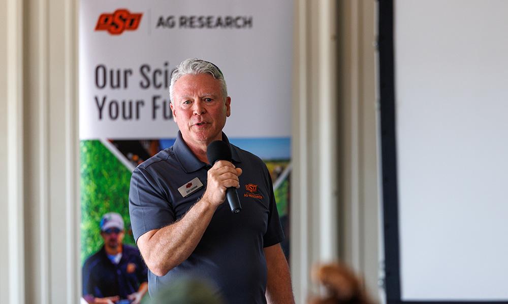 Scott Senseman speaking into a microphone.