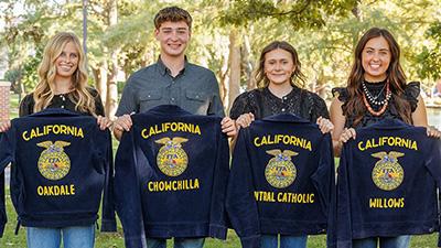 Four former California FFA members hold their jackets.