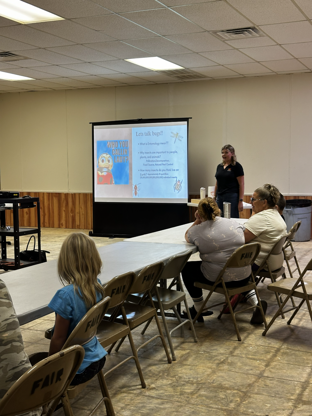 Participants attend a 4-H entomology workshop, learning about insects and their importance through an educational presentation and discussion.