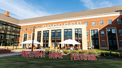 Welcome Home Ferguson yard signs stand on the front lawn of the Ferguson College of Agriculture.