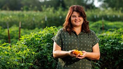 DeKalb-Myers natural portrait holding tomatoes.