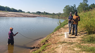 Individuals conducting water research.