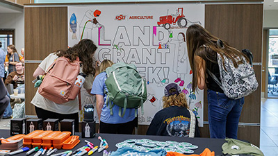 Students color a poster during Land-Grant Week.
