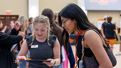 A student talks to a campus representative with an iPad.