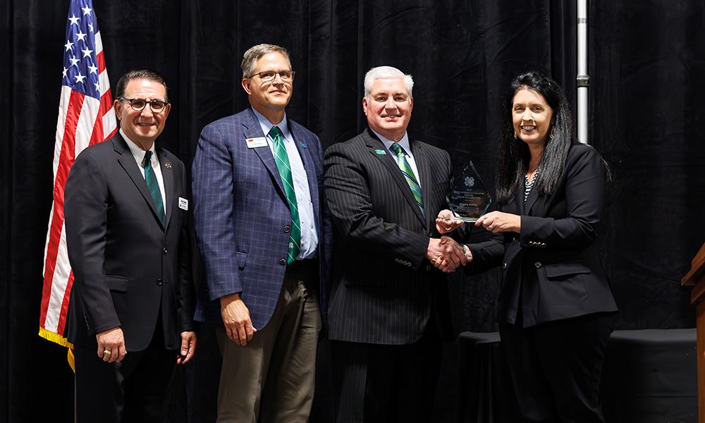 Blayne Arthur receives her 4-H Outstanding Alumni Award.