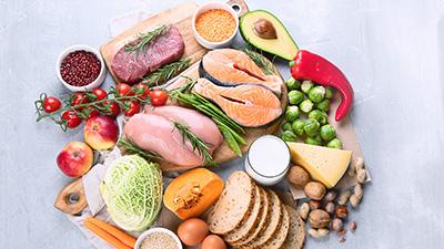 An array of meats, fruits and vegetables on a platter.