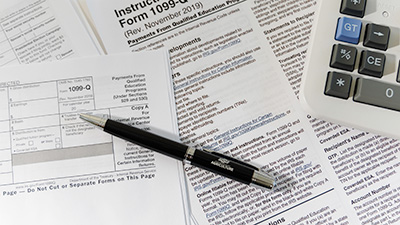 Tax documents, pen and calculator.