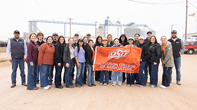 Ferguson College of Agriculture students stand with an orange flag.