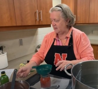 women canning over a stove